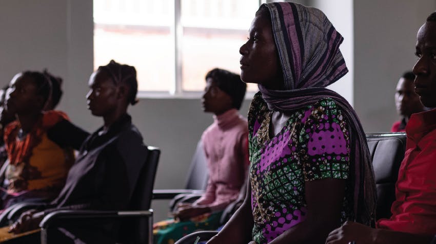 Image of Tanzanian women who are sitting together in a classroom.