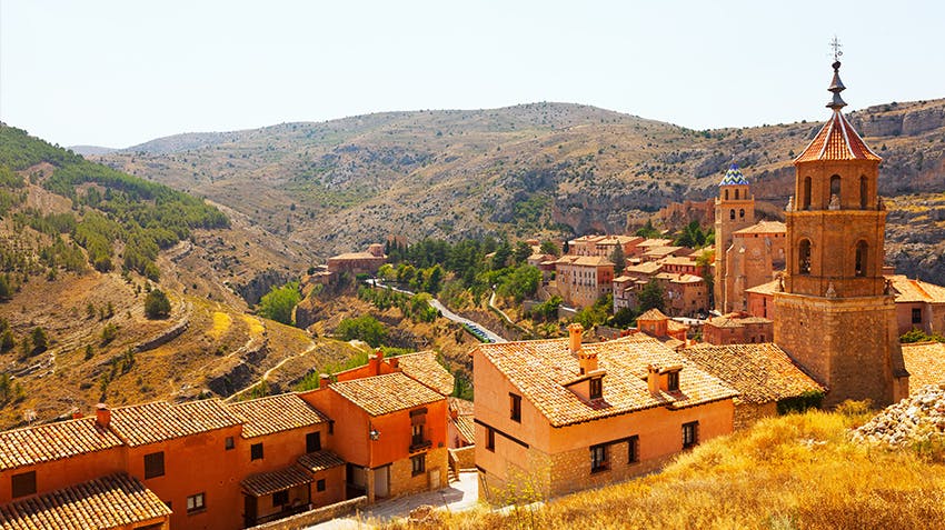 Erasmus+ students in front of an old building jumping with joy