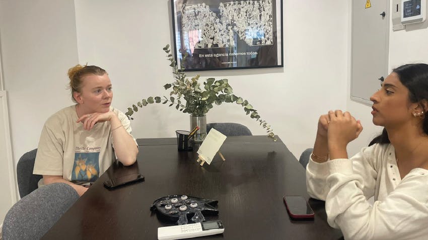 Intern pictured discussing internship program in Spain, with Intern Abroad HQ Program Manager