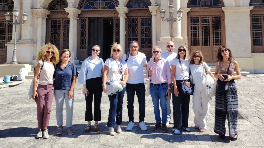 Internship coordinators in Heraklion, Crete, posing outside of a historical building in the tour. Representing internship orientation in Crete and supporting team members, to assist the intern abroad experience.