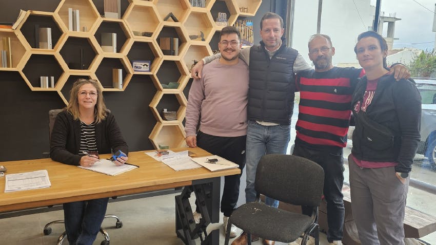 Interns at internship placement in Crete, Greece, pictured with representatives from the host organization.