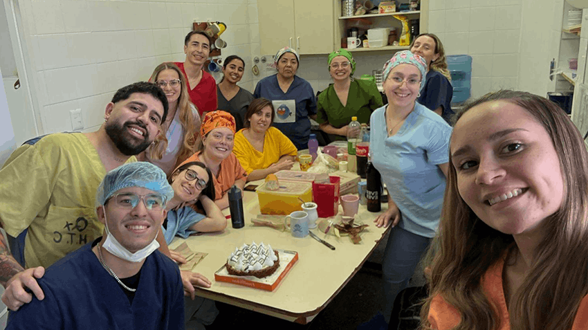 Sia pictured during her medical internship in Argentina, enjoying a social moment for a birthday, with medical colleagues.