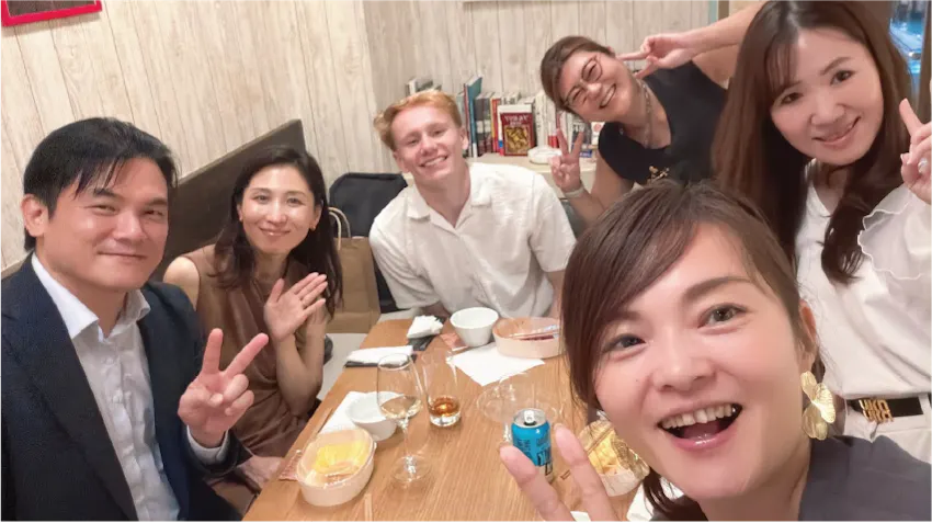 Adam is pictured at a dinner in Tokyo with colleagues