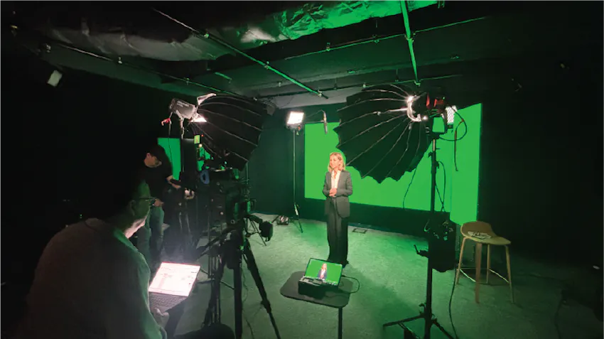 A reporter is photographed standing in front of a green screen while filming in Sydney, Australia, taken during Ryan's Film and Media Production internship