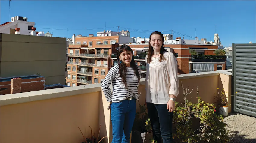 Interns in Spain pose on the balcony of a building