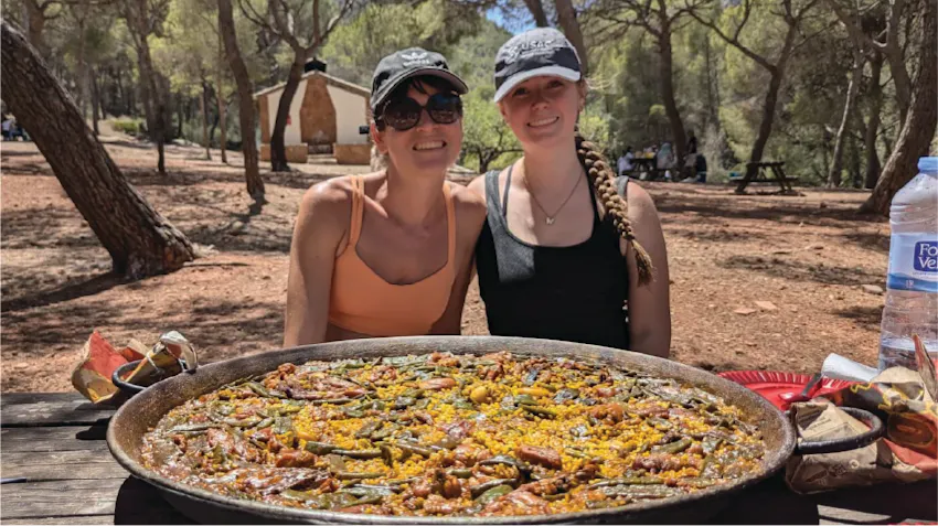 Example photo to show two friends in Spain, posing with a large meal