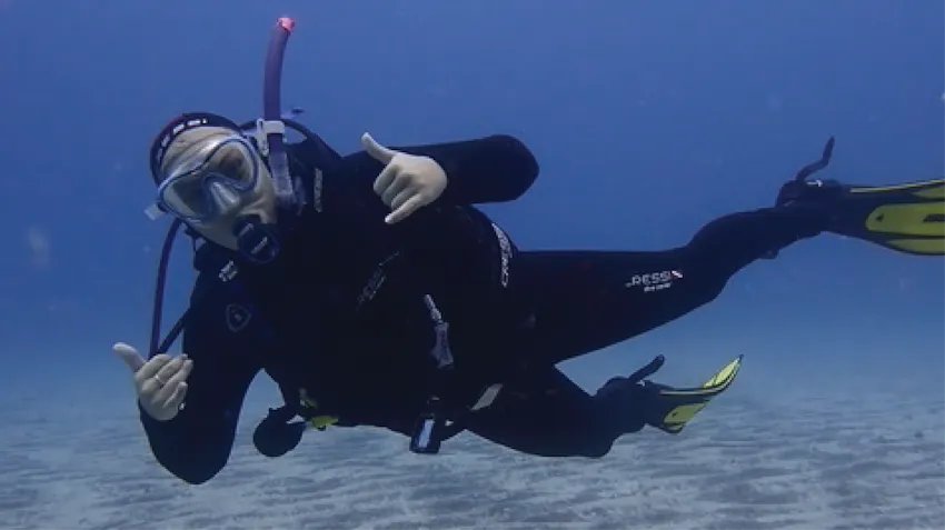 An underwater diving photograph of a marine conservation intern in Tenerife, Spain