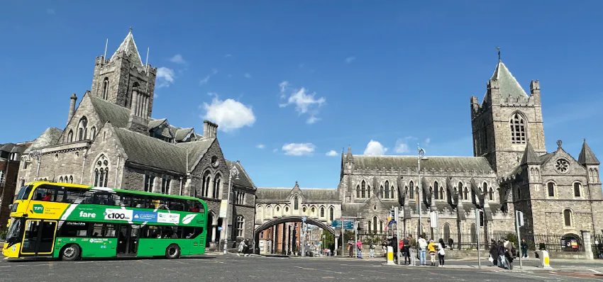 Photograph in Dublin of a city bus parked outside of a historical site.
