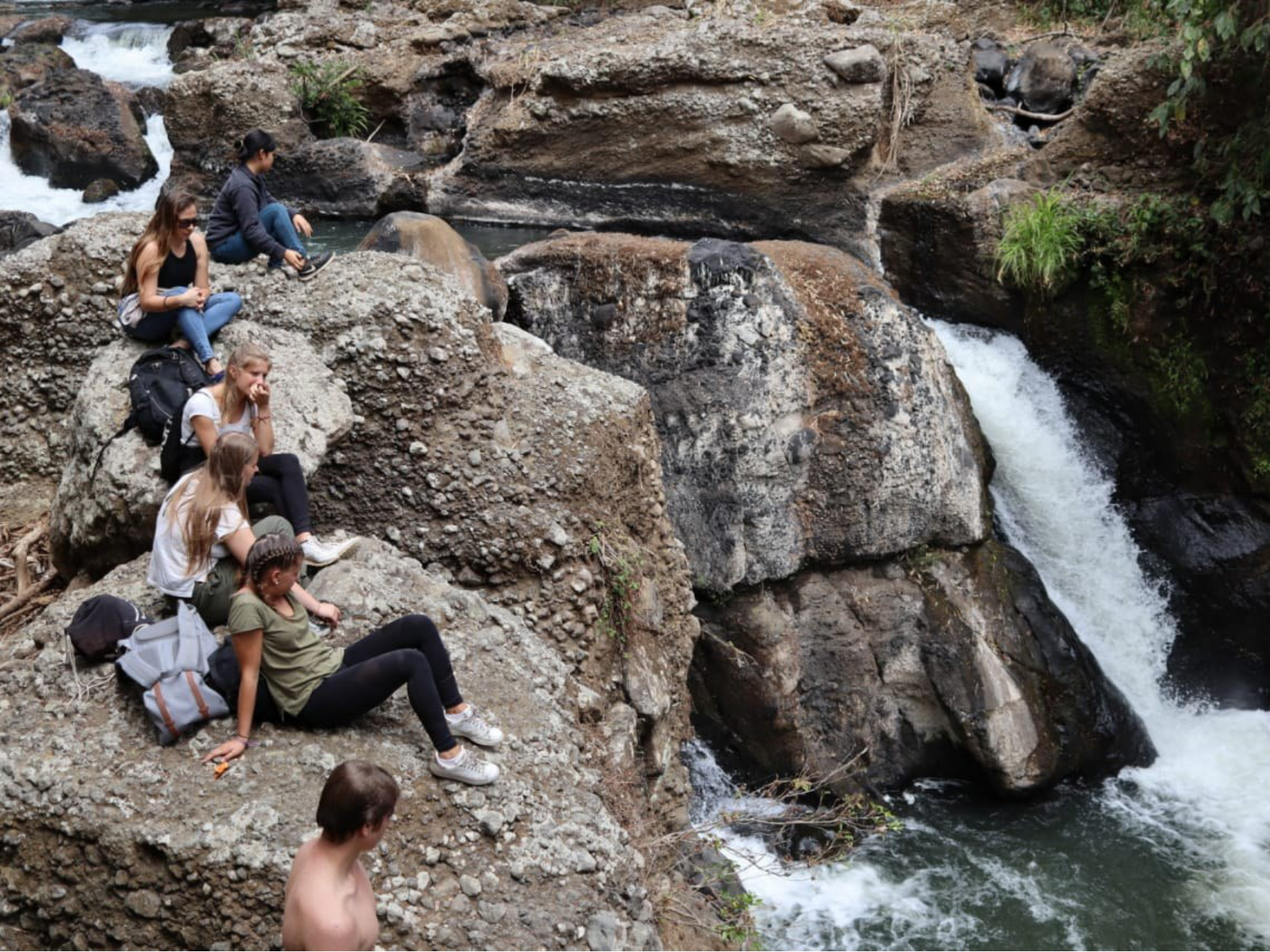 Interns relaxing at a waterfall in Costa Rica