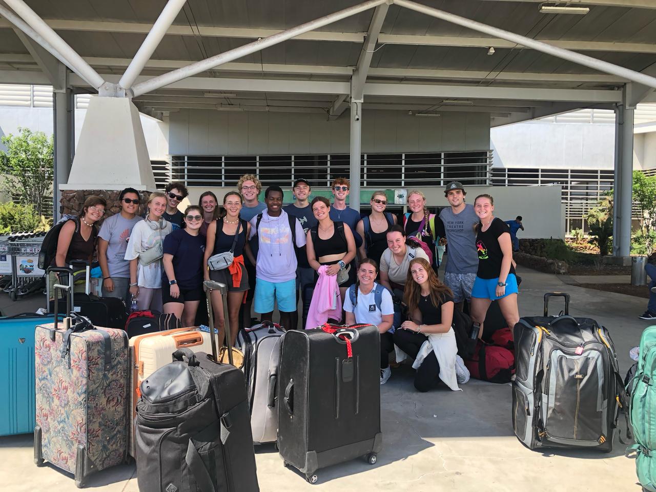 A group of newly arrived travelers in the Galapagos Islands, pictured next to their luggage