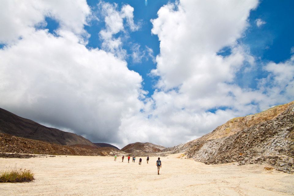 View of people walking together towards the horizon