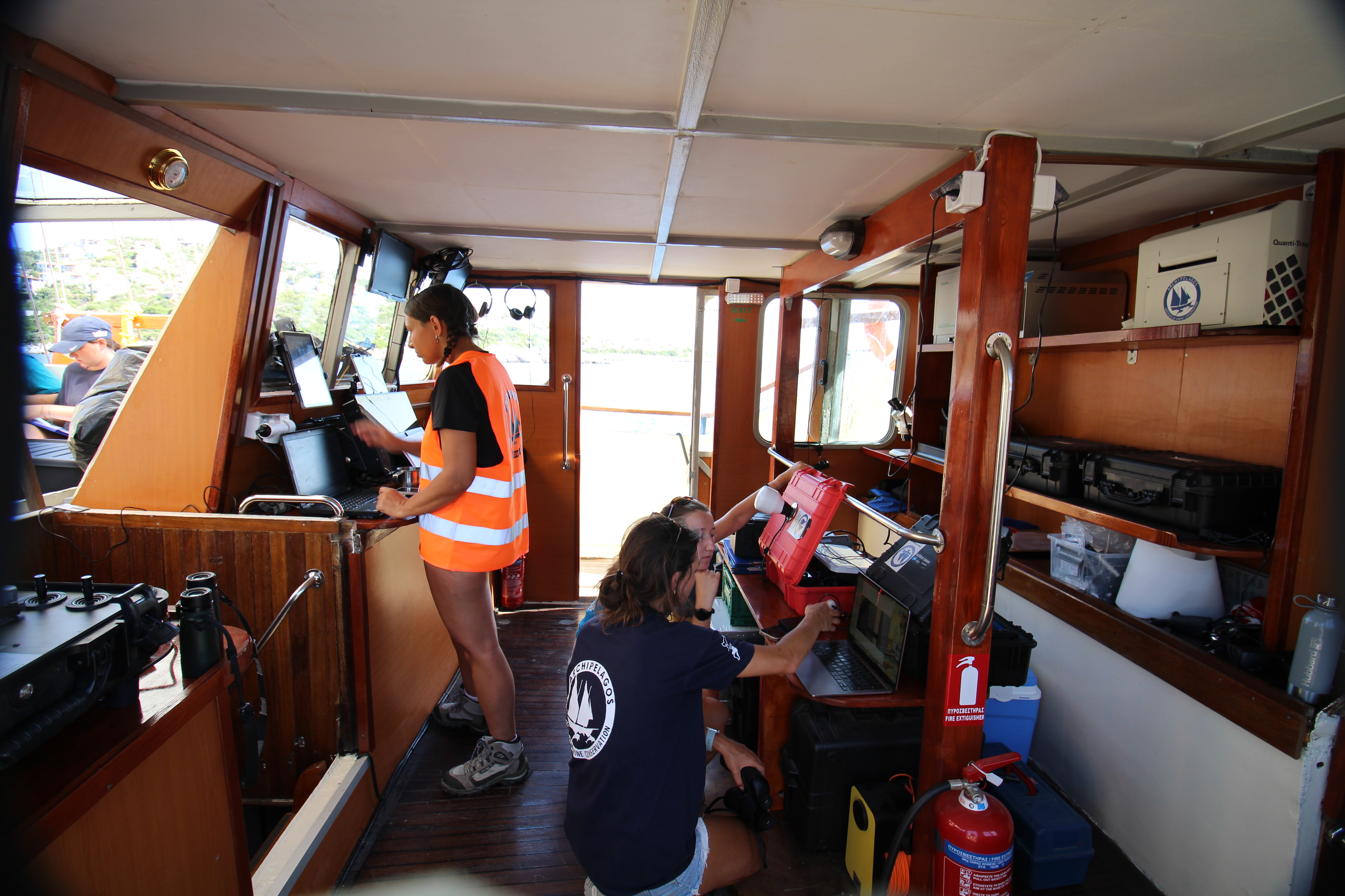 Marine Conservation Research Expedition working onboard the vessel and learning about equipment