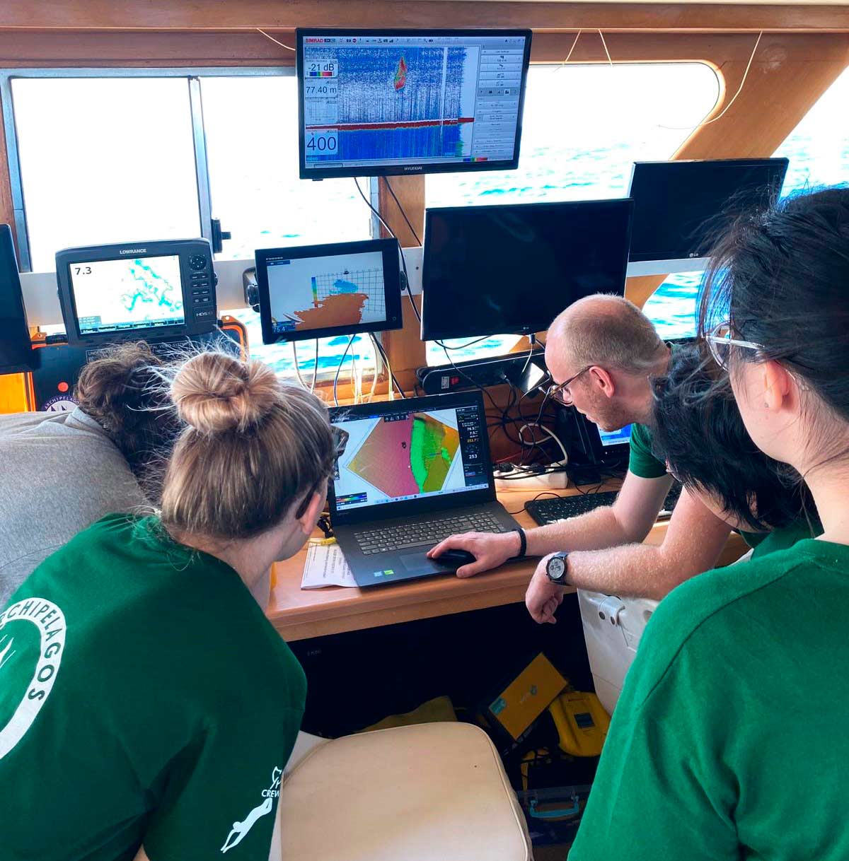 Marine Conservation Research Expedition reviewing GIS data on-board the vessel