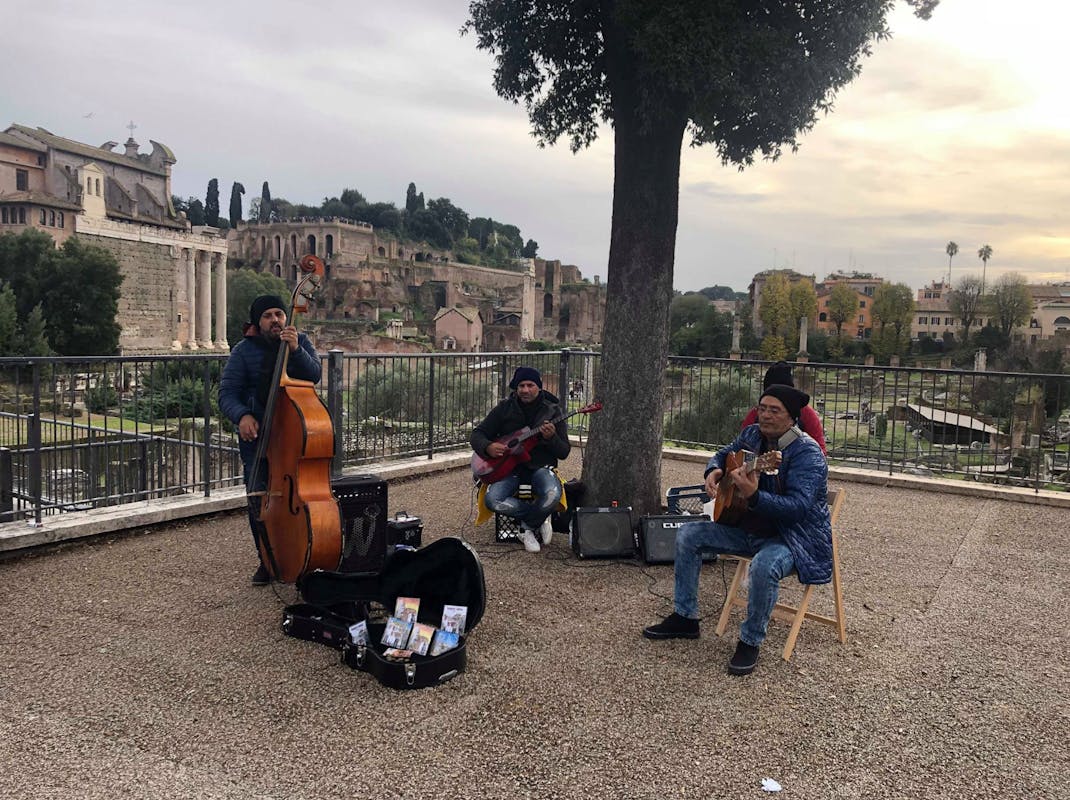 Street musicians play outside the colosseum and Roman Forum, Intern Abroad HQ
