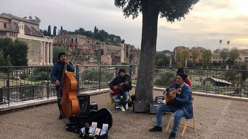 Street musicians play outside the colosseum and Roman Forum, Intern Abroad HQ