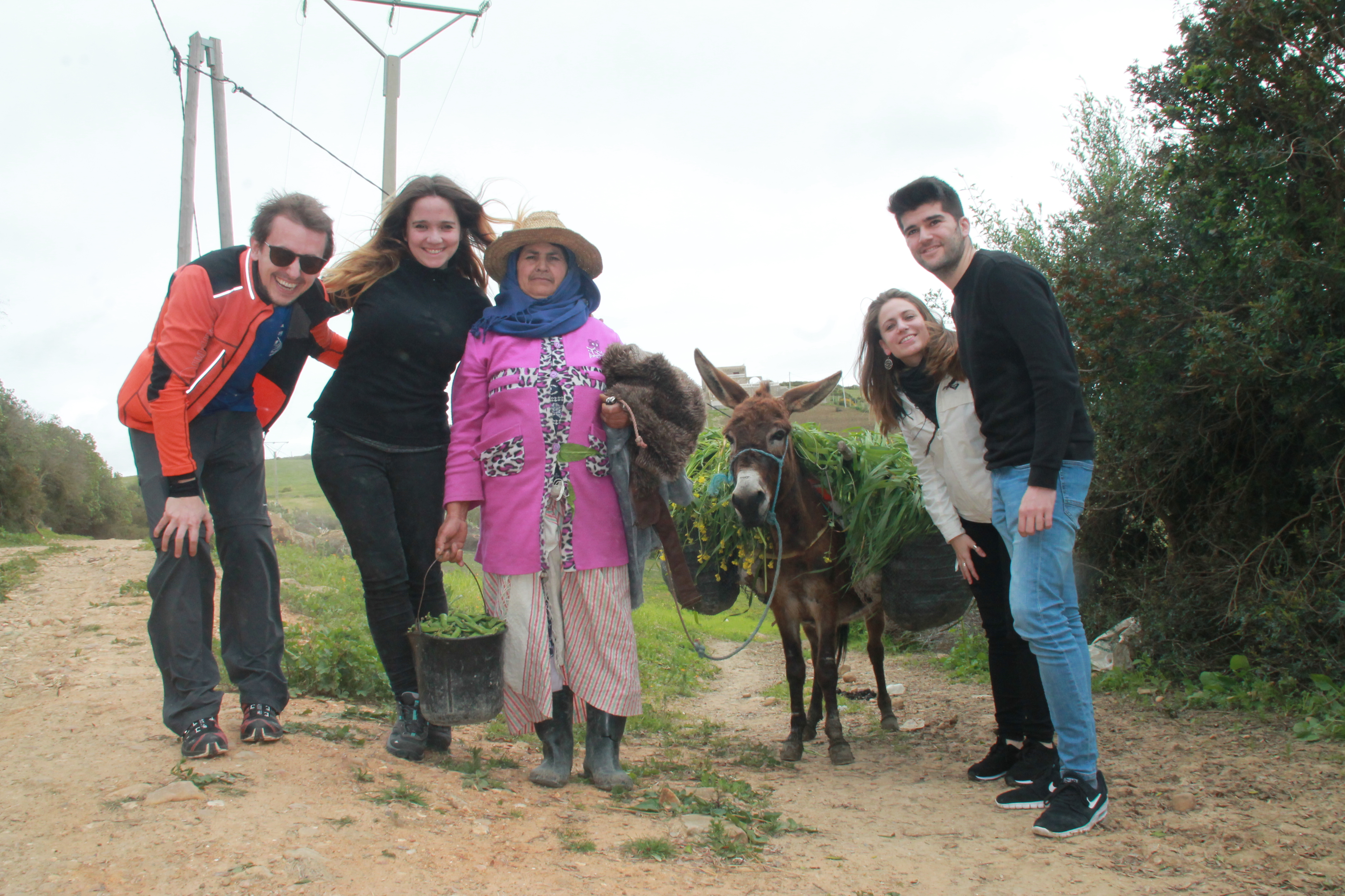 Children and community members in Morocco with a donkey