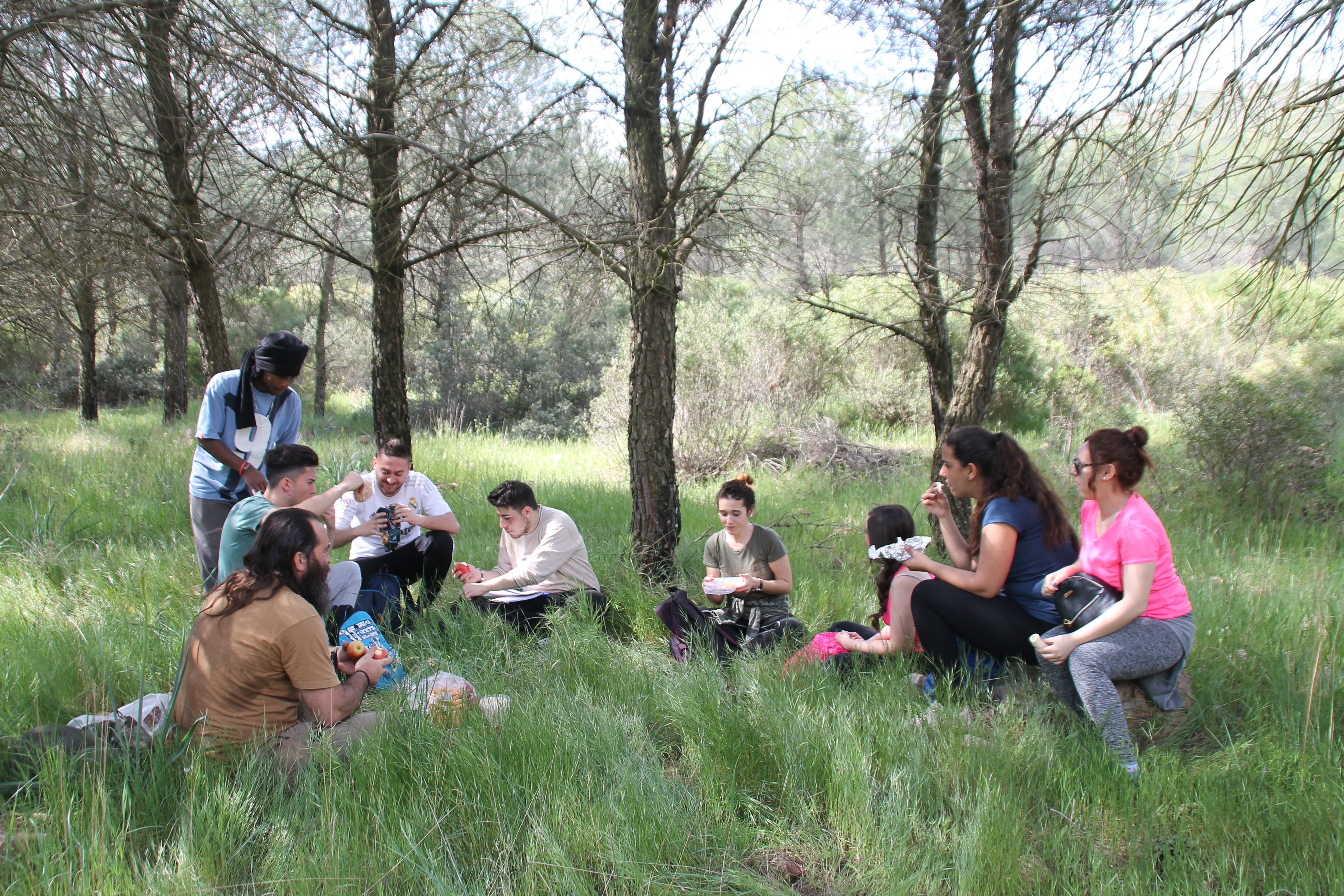 A mixed group of student interns in Morocco, eating lunch during a fieldwork excursion