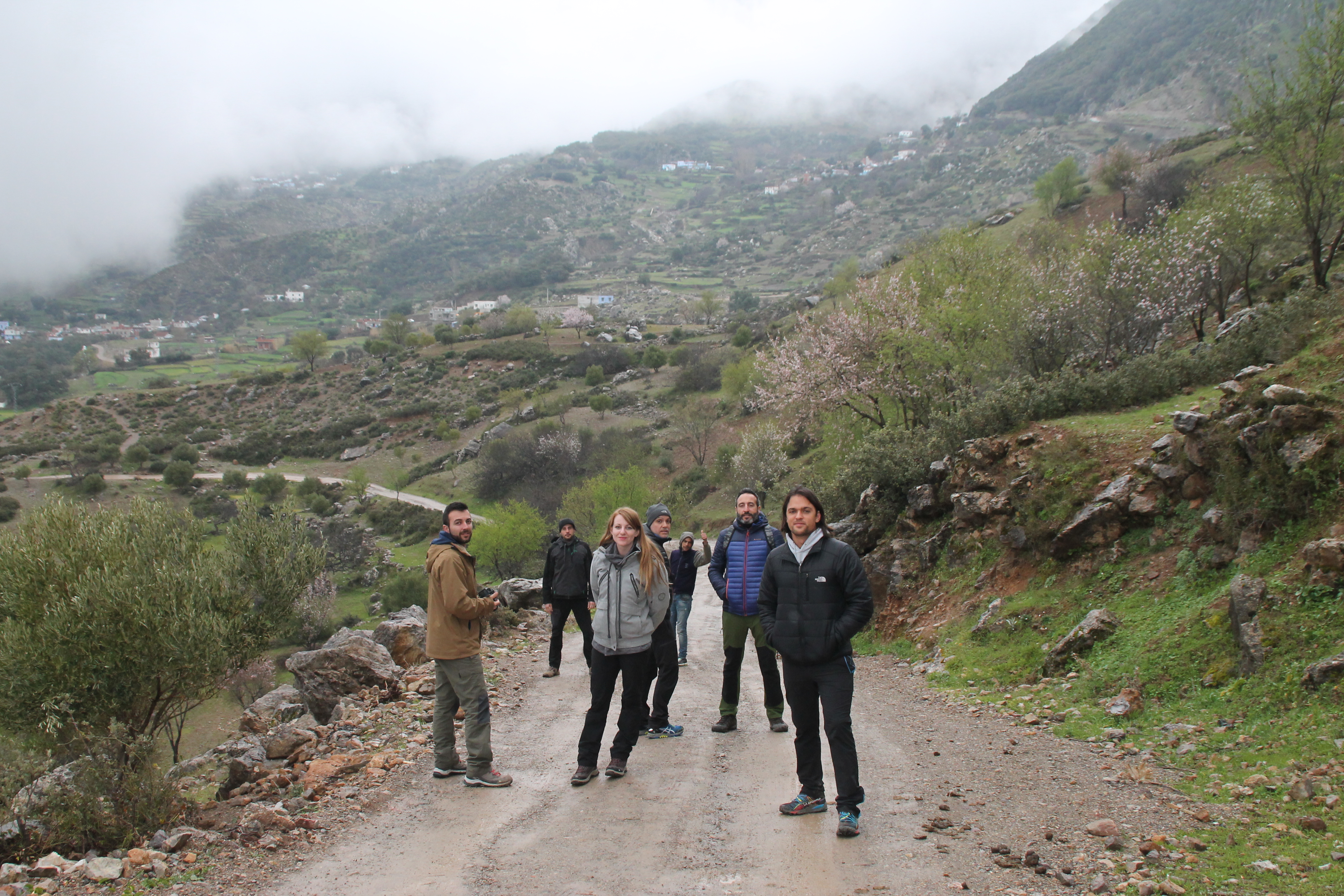 A mixed group of student interns in Morocco, walking together on a trail