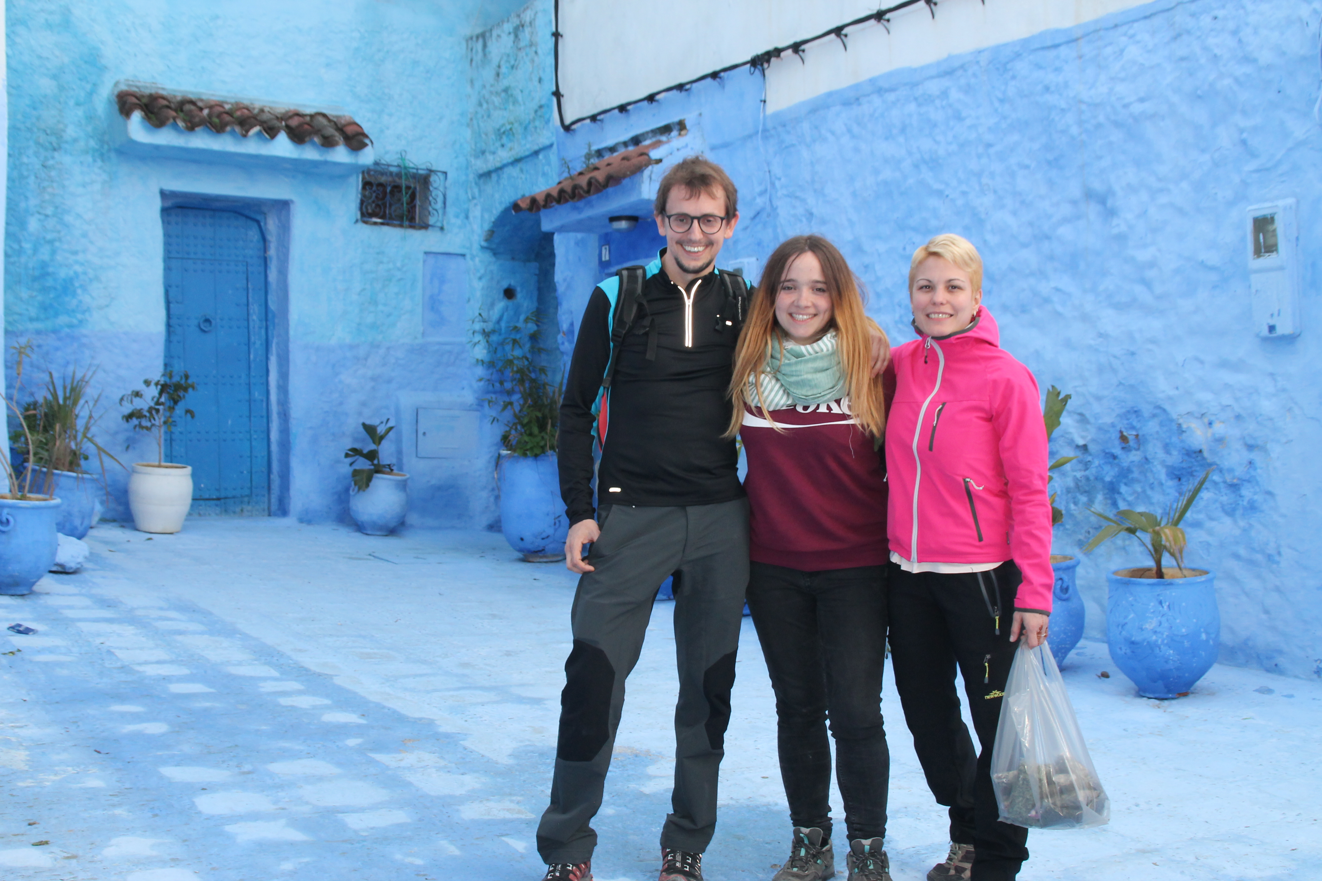 Students standing against a blue building backdrop in a Morocco 