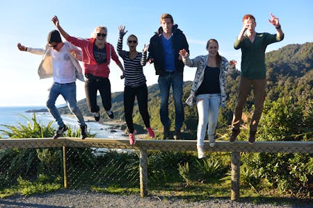 Interns jumping at the beach in New Zealand
