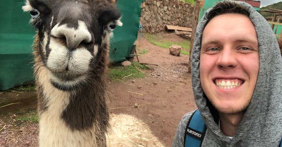 Intern poses with a cute llama in Peru