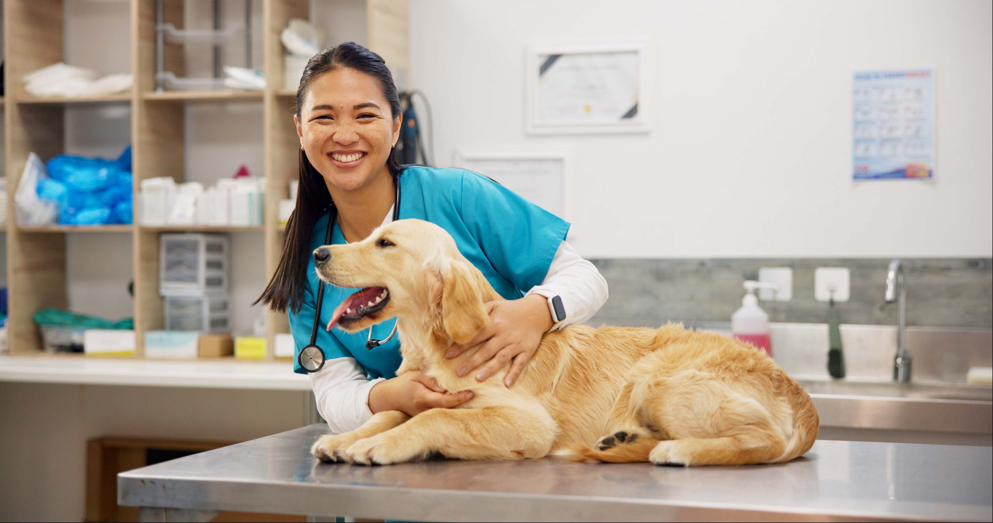 Vet nurse posing with happy dog