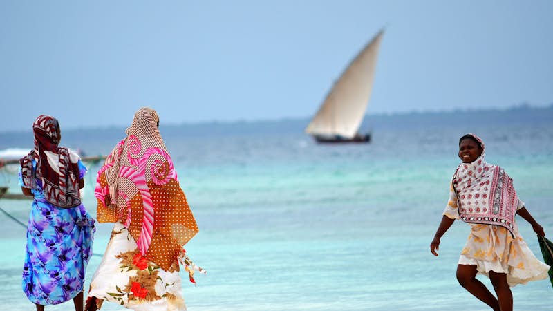 Women and children on the beach in Zanzibar, Intern Abroad HQ