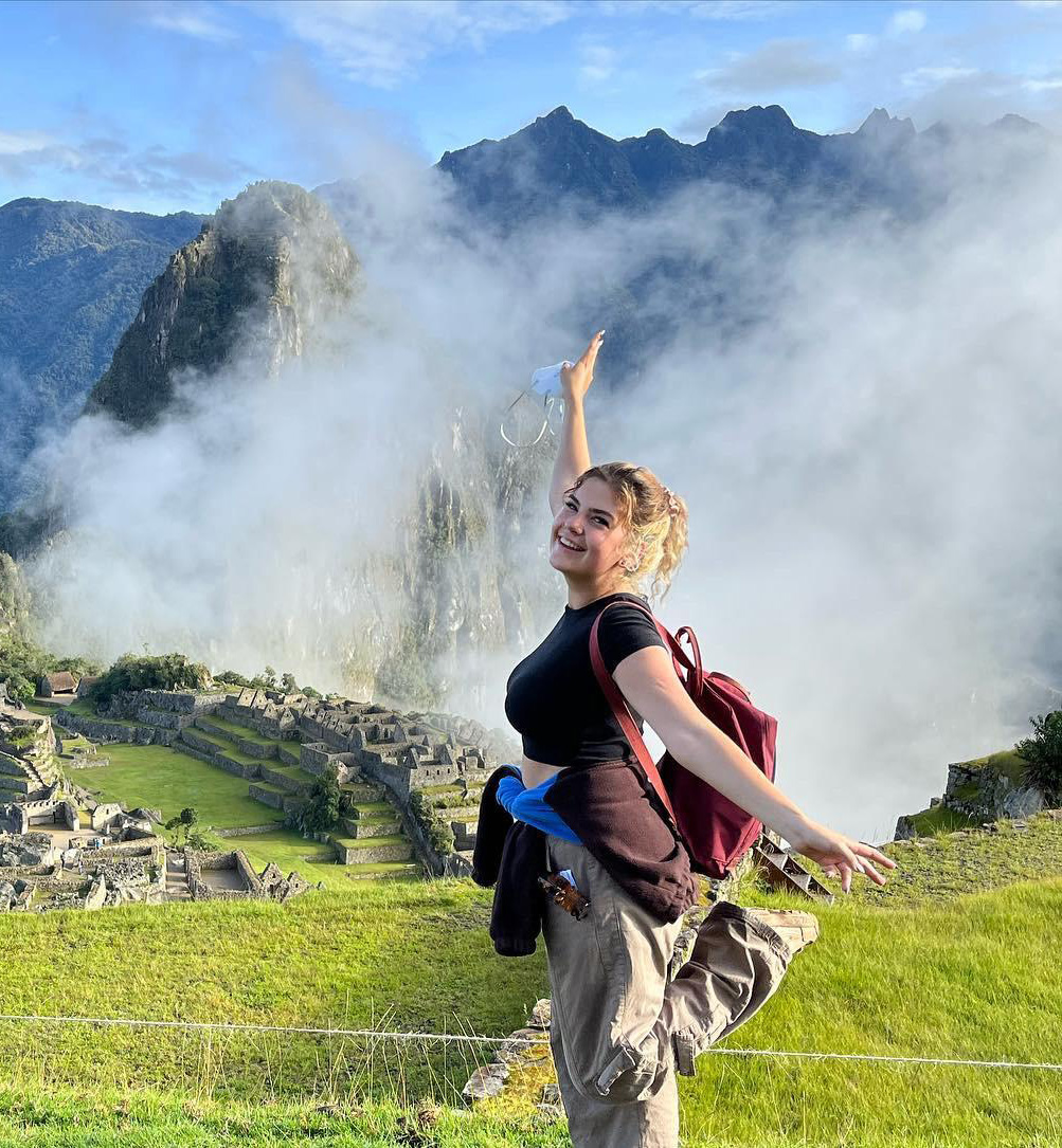Smiling intern poses at Machu Picchu, celebrating her international internship experience.