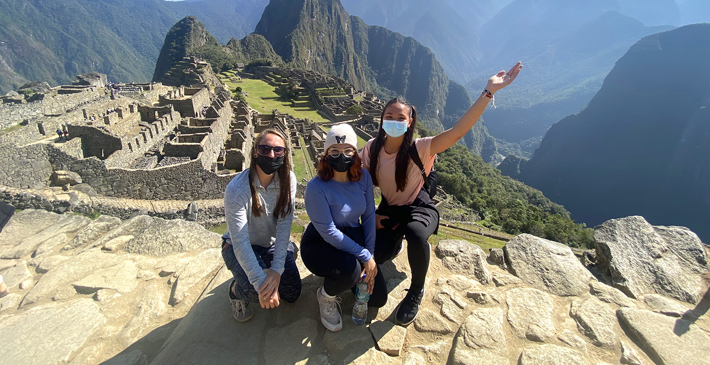 Local internship coordinators in Peru standing outdoors, smiling and ready to support international interns.