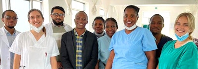 Group of interns and healthcare staff smiling inside a hospital during a medical internship program.